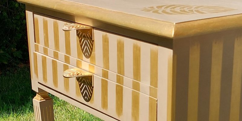 Parte frontal de una mesita de dos cajones decorada