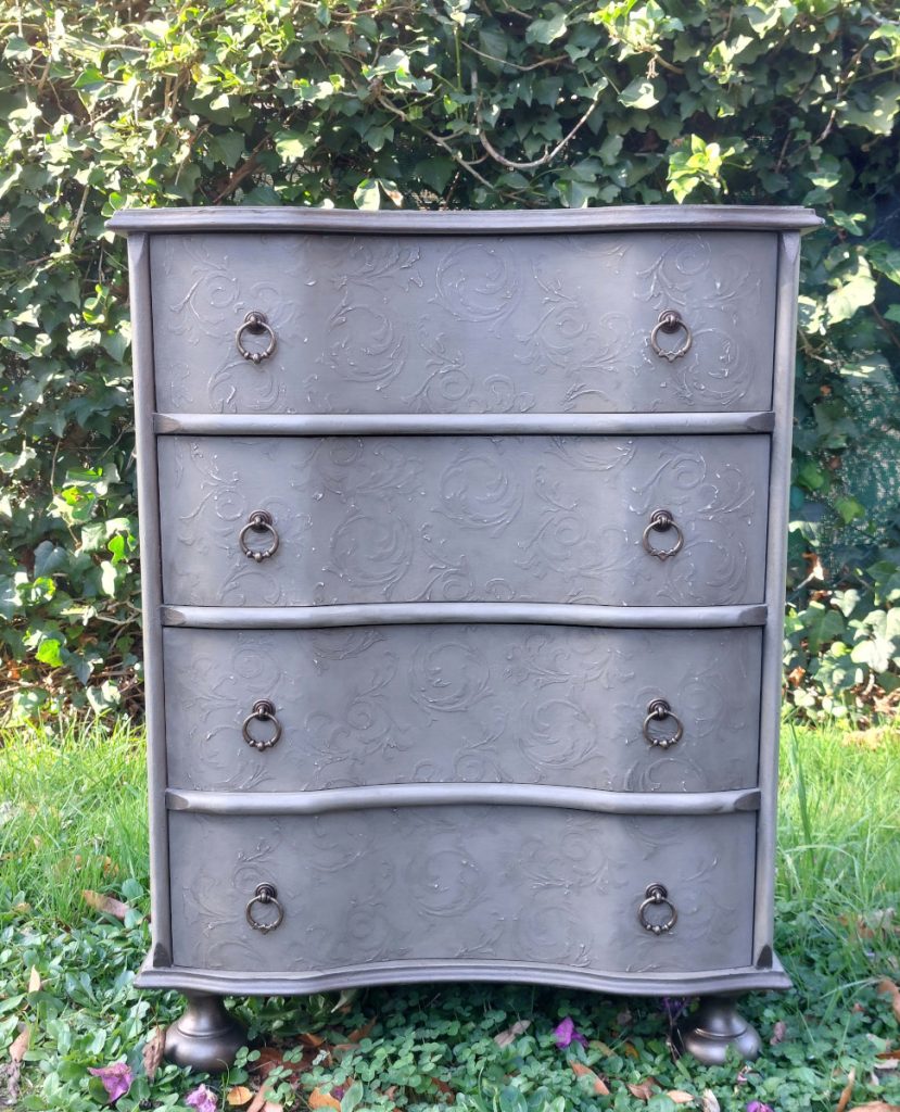 Mueble con cuatro cajones, pintado con relieves