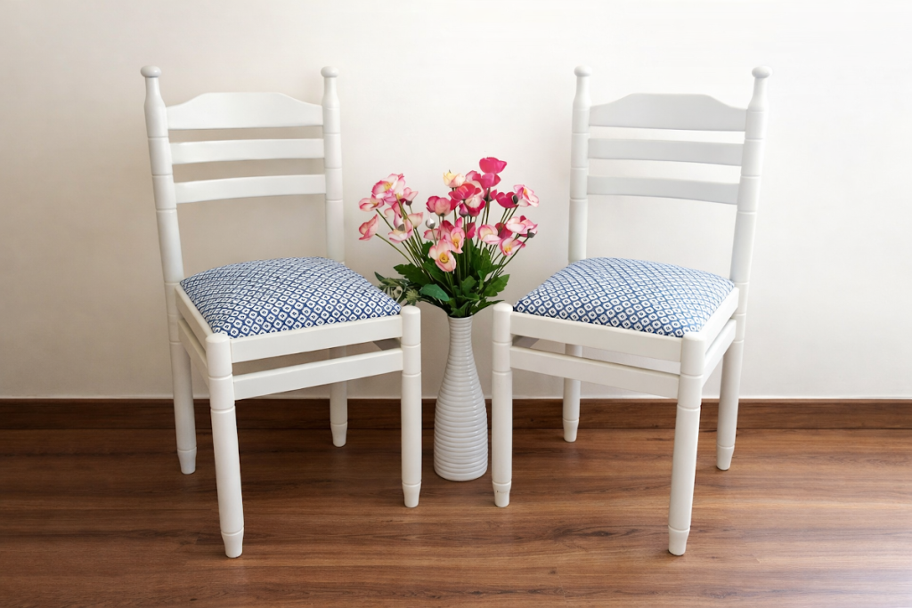 Dos sillas pintadas en color blanco y tapizadas con tela estampada en azul y blanco